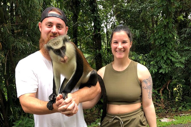 Guests with a Mona monkey on the Grenada nature tour